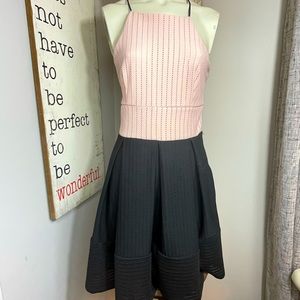 Twilight Simon’s blush and black color block halter box pleat dress
